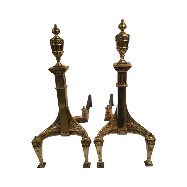 A lovely pair of classic brass andirons, made in the mid 20th Century and measuring 21 inches high by 25 inches long and 9...