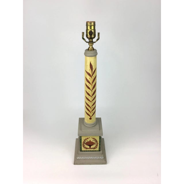 Victory motif of a trophy with a laurel wreath encircling is painted upon this Column table lamp will bring any home a...