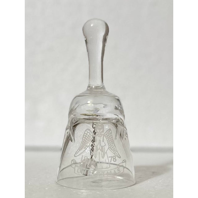 Crystal bell with an angel and the words “Christmas 1978”. Three stars cut into the crystal. 2” x 2” x 4”.