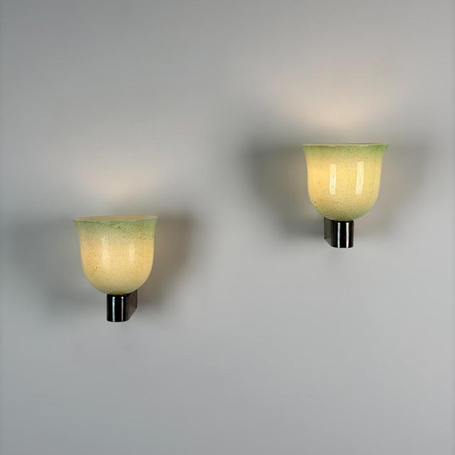 An exceptionally refined pair of wall sconces designed by Tomaso Buzzi for Venini during the 1940s, embodying the...