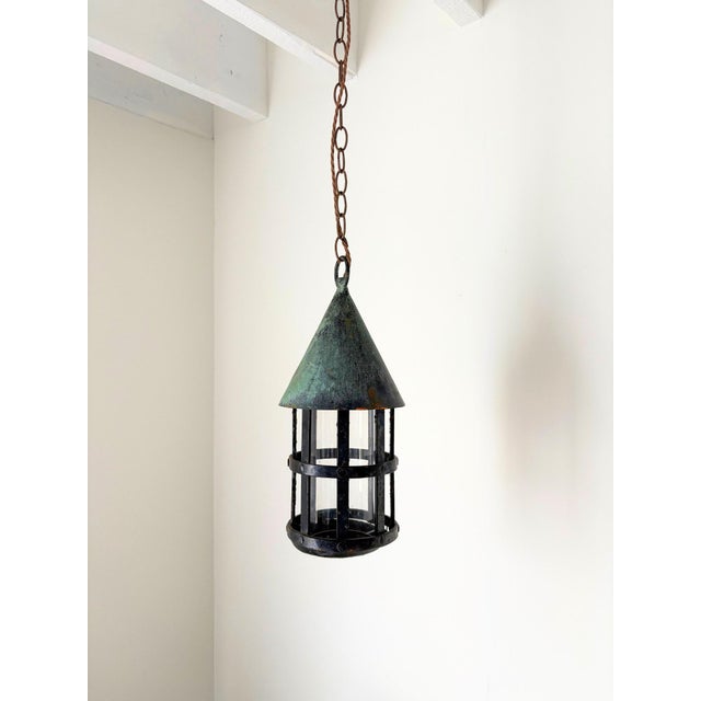An early 20th century vintage French hanging lantern with verdigris finish. This Arts and Crafts design ceiling light has...