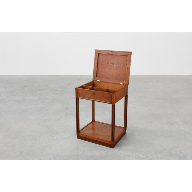A refined and expressive example of early 20th‑century Dutch design, this Amsterdam School side table or small cabinet...