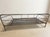 A distinctive vintage daybed frame with a chrome-plated tubular steel structure and woven metal mesh base. Its simple...
