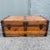 A character-rich antique wooden trunk featuring a desirable low-profile, flat-top form with warm aged wood and substantial...