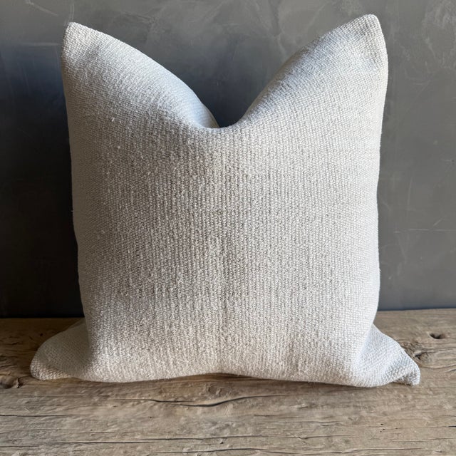 Creamy white hemp rug pillow with original seams. Soft hand, linen blend backing with zipper closure. Spot cleaning is...