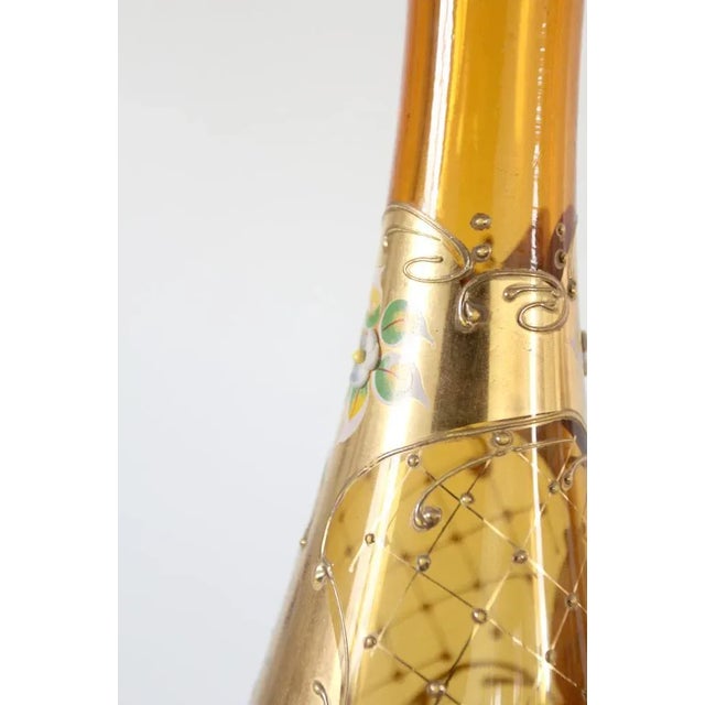 This mid-century Italian glass decanter set features a tall, slender amber decanter with two matching cordial glasses,...