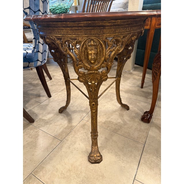 Gilt Cast Iron Table base with a Marquetry top, English late 19th Century. The Patina on the Gilt Iron is Magnificent and...