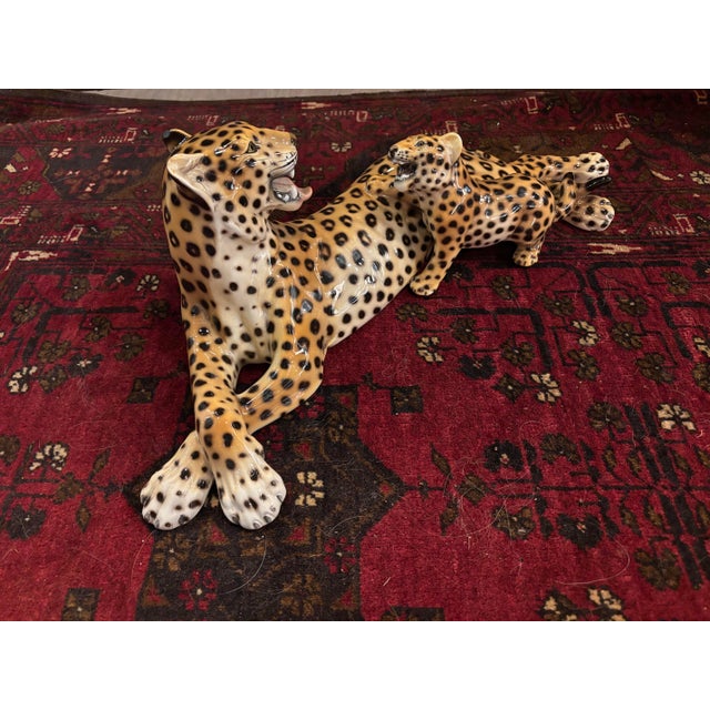 Striking vintage Italian ceramic sculpture by Ronzan, featuring a reclining mother leopard with her playful cub....