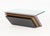 Modern Cantilevered Glass Top Coffee Table, with metallic patinated metal base and rectangular glass top. 16" H x 35.5" W...