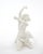 This elegant Art Deco white glazed porcelain sculpture depicts a graceful female dancer captured in a dramatic and highly...