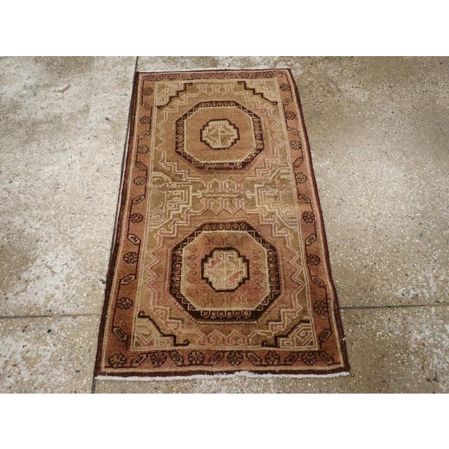 An antique East Turkestan Khotan throw rug handmade during the Early 20th century. Measures: 1' 11" x 3' 6"