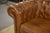 Chesterfield sofa in brown leather with deep button tufting. Enveloping silhouette with rolled armrests and a three-...