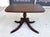 Early 20th Century mahogany accent table featuring a classic pedestal base with carved spiral column and claw feet....