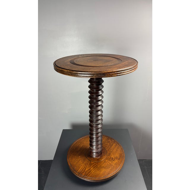 Gorgeous tall French side table from the 1940s- 1950s constructed in dark oak. The bases are generally made of...