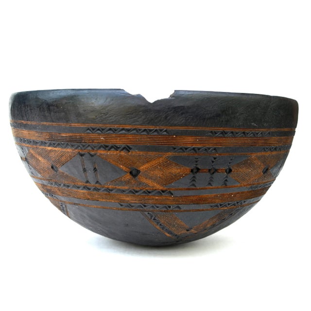A wonderful early 20th century wood bowl carved of a single piece of wood with geometric patterns around the exterior, by...