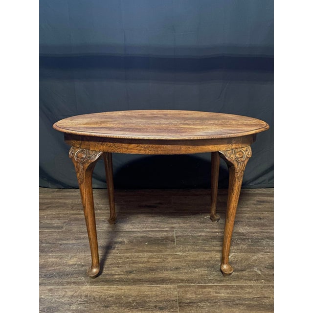 Elegant, simple French oval occasional table, crafted in solid oak with elegant carved Queen Anne legs and beautiful...