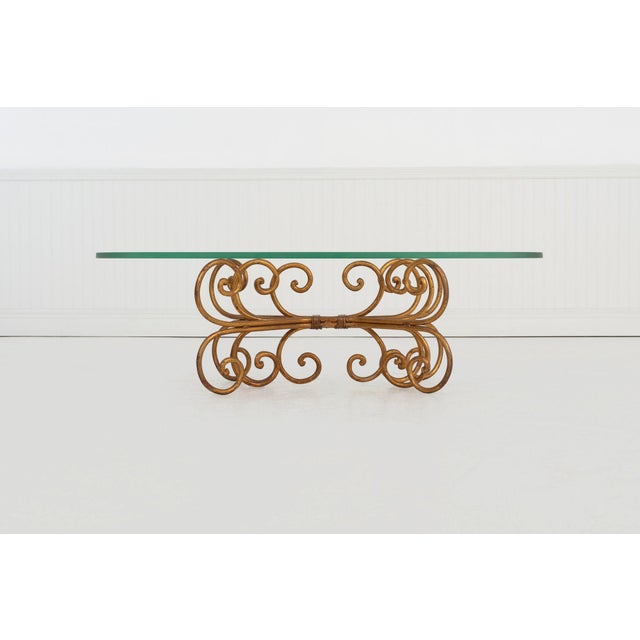 Gilt Wrought Iron Coffee Table in the Style of Maison Jansen Italy, circa 1960s A sculptural gilt wrought iron coffee...