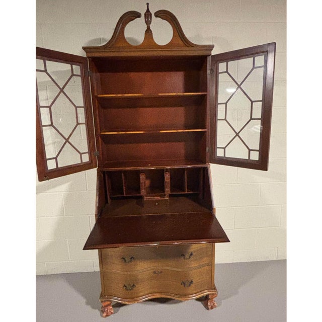 Mahogany chippendale style serpentine secretary desk with bonnet top.