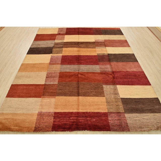 This contemporary geometric Gabbeh rug is hand-knotted with an all-wool pile on a cotton foundation. This rug is new and...