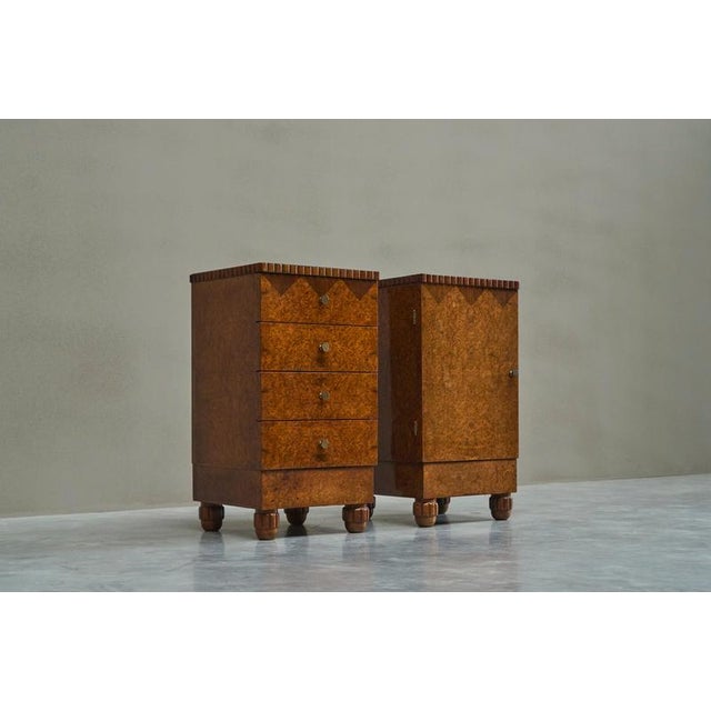 A truly magnificent pair of art deco cabinets in burl veneer, glass and patinated brass. Europe, 1930s. This pair of...