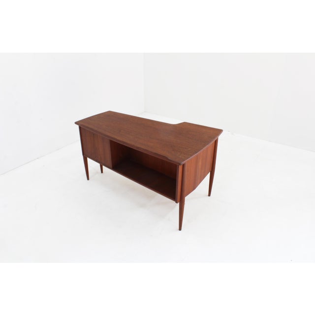 Vintage Danish teak mid century desk designed in the 1960s. Scandinavian design with beautiful detailed handles and wood...