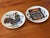 Charming pair of small decorative Americana ceramic coaster plates, featuring a Chanticleer weather vane and a war drum...