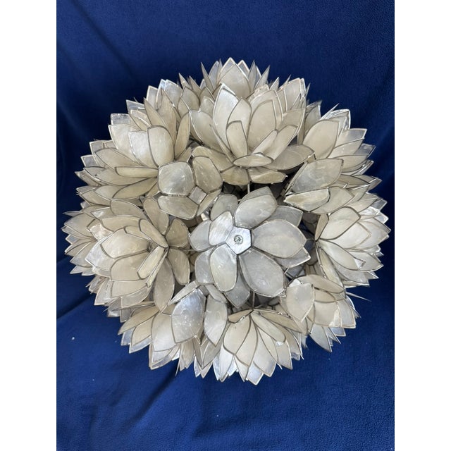 Beautiful statement piece featuring layered lotus flower blossoms handcrafted from natural capiz shell. Approximately 18"...