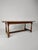 This antique early 19th-century French farmhouse dining table with rustic charm and timeless elegance. Crafted from solid...