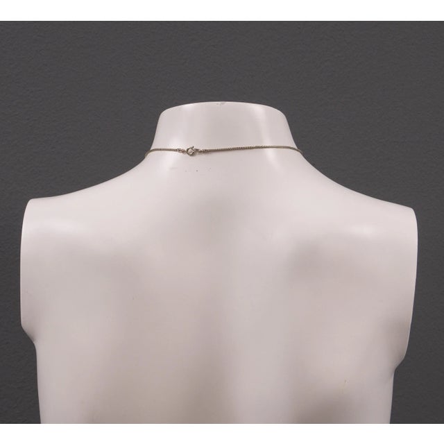 A stylish heart necklace from the 1960s. Its simple form captivates with its interplay of organic and geometric shapes....