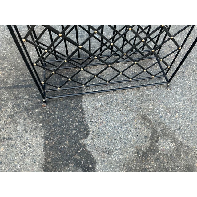 Decorative iron black granite top wine rack. Rack is in excellent condition. Rack has removable black granite inset. Claw...