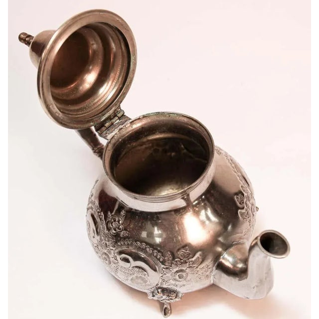 Traditional vintage silver plated and brass Moroccan tea pot, embossed with traditional repousse design, nicely aged,...