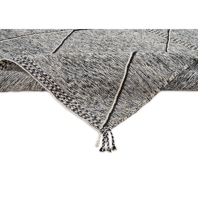 Elegant handwoven wool rug showcasing bold geometric diamonds in Midnight Black and Ivory. Expertly crafted by skilled...