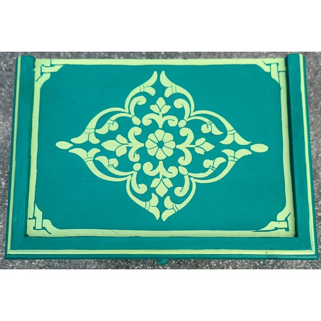 A stunning hand‑painted Moroccan nightstand showcasing the vibrant artistry and traditional Zoua9 woodwork Morocco is...