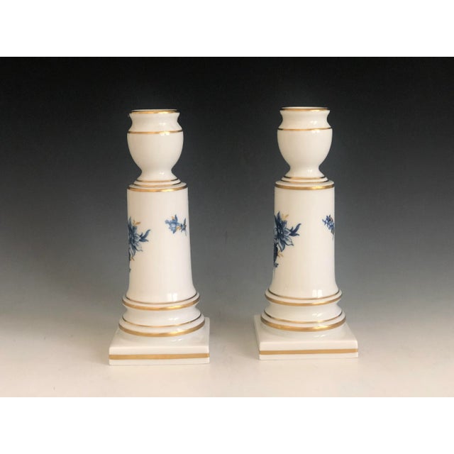 Beautiful pair of high-quality Meissen porcelain candlesticks with a hand-painted blue floral insert decor. Gold trimmed....