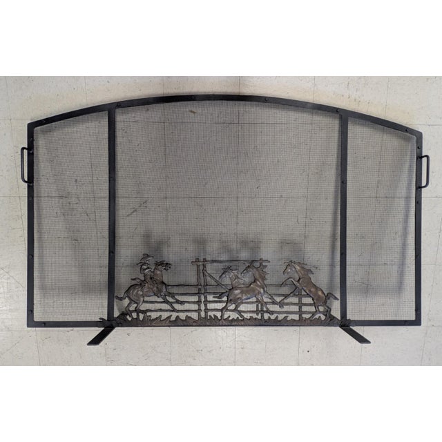 A bold and evocative Western fireplace screen by noted Wyoming craftsman John B. Mortensen, celebrated for his sculptural...