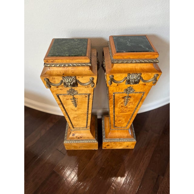 Pair of Burlwood Pedestal with Marble Top and Brass detail. Lion Head brass design on all 4 sides of each pedestal. French...