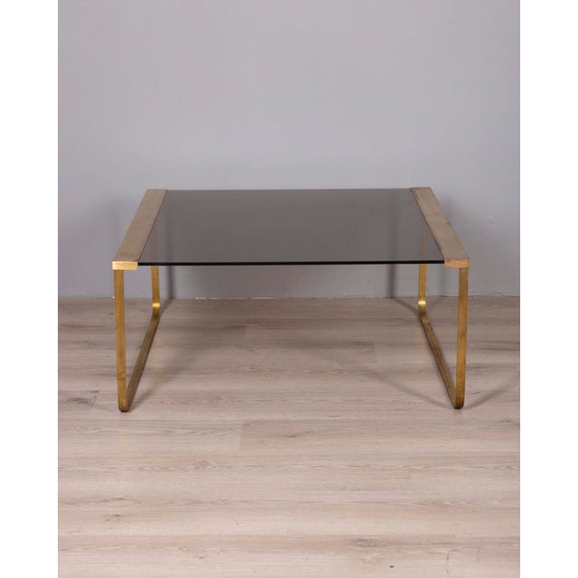 Coffee table with gilded brass structure and smoked glass top, Italian design, 1960s.