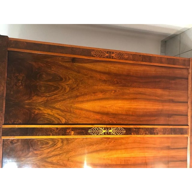 Elegant Biedermeier two-door armoire from Vienna, dating to 1820–1830. The piece features walnut veneer with beautiful...