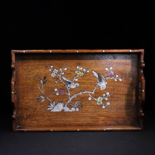 This elegant Chinese-style hand-held tray is crafted from fine Huali wood, celebrated for its rich grain and warm natural...