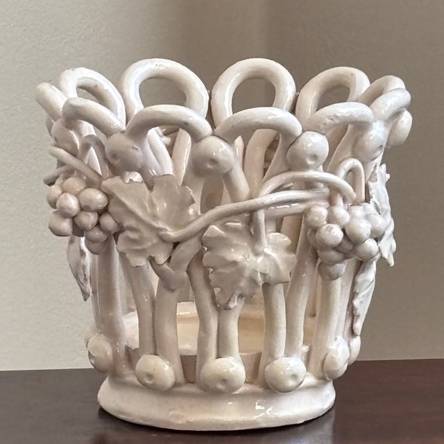 A beautiful mid-20th century ceramic openwork cachepot with a lattice-style body and applied molded details grapevines,...