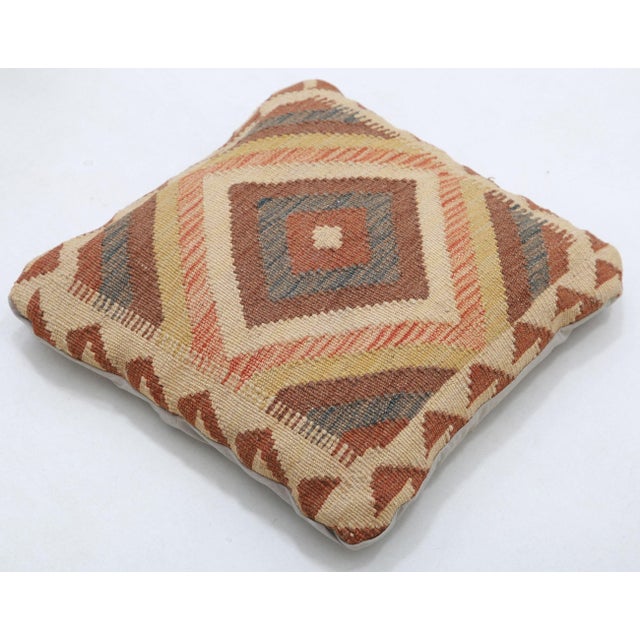 A one-of-a-kind handwoven Afghan wool kilim accent pillow featuring concentric diamond medallion. Cut and sewn by hand...