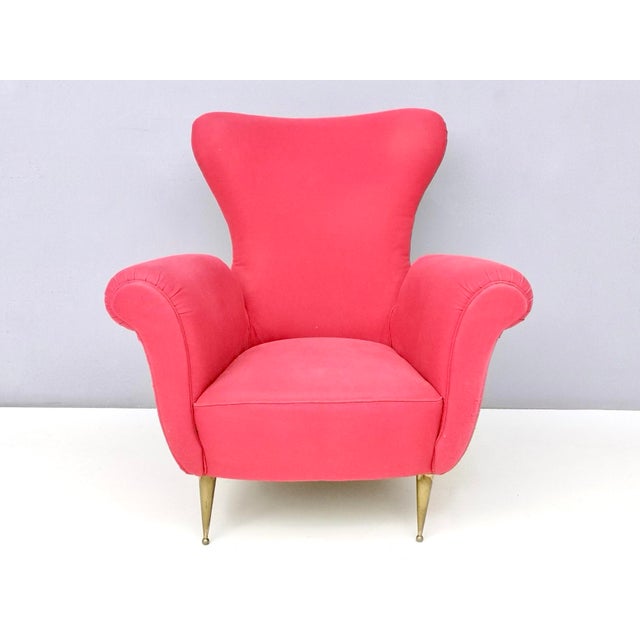 Made in Italy, 1950s. This armchair features brass feet and its original cotton upholstery. It is vintage, therefore it...