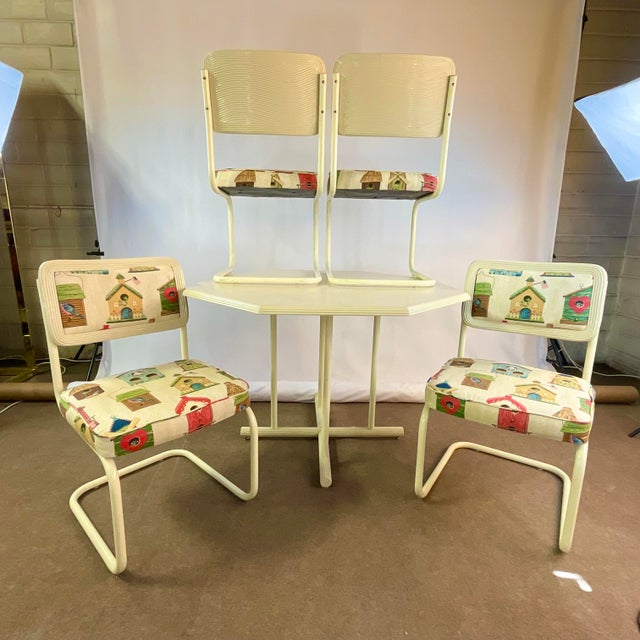 This is a charming Coastal Casual Dining Set from the 1980s. It has an Octagonal shaped table that is trimmed with Pencil...