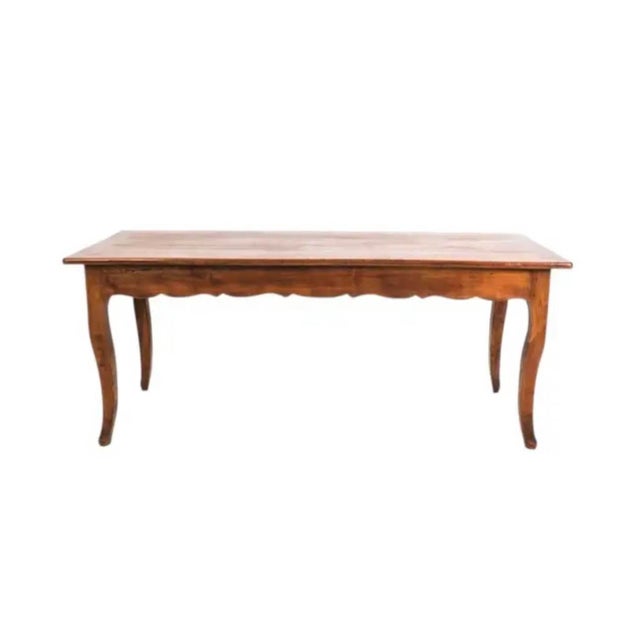 French Provincial Cherry Farmhouse Table. Table features a scalloped apron, cabriole legs, and two storage drawers, one at...