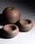 Studio ceramic trio by Mario Enke, consisting of one rounded vase and two matching bowls in hand-thrown terracotta with a...