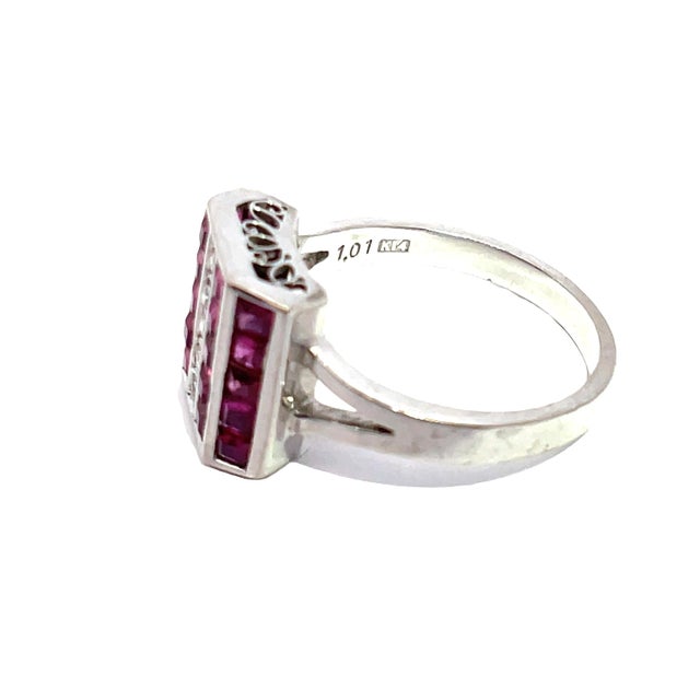 Discover the exquisite elegance of our 14k white gold ring, adorned with stunning pink diamonds and a vibrant ruby....
