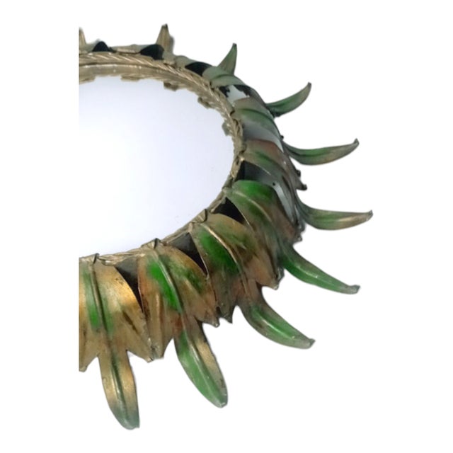 Discover this impressive vintage sun mirror made of gold metal with a spectacular decorative design that evokes the...
