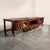 A sculptural walnut partner desk and integrated stereo console combining exceptional furniture craftsmanship with high-...