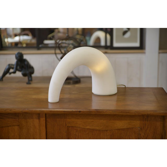 “Thor” table lamp by Fontana Arte. White opaline glass diffuser forming an arch, for soft and even light. Highly...