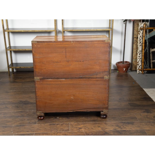 An English mahogany campaign chest from the mid 19th century, with five drawers and brass hardware. Created in England...